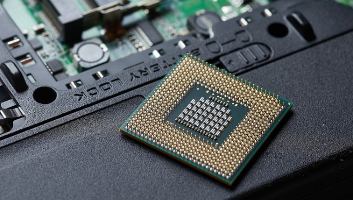 A CPU with golden pins ready to be placed