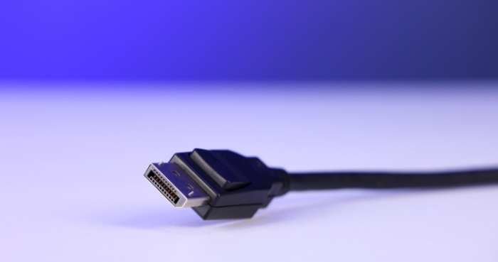 A DisplayPort cable against a blue gradient background