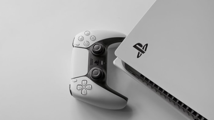 A PS5 console and its controller on a white background