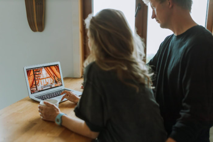 A couple watches a video on a laptop