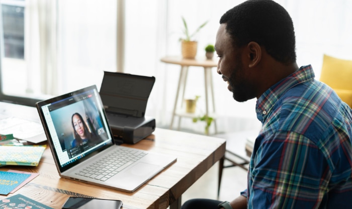 A man participating in a video call on a laptop