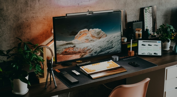 A monitor on a desk with office items