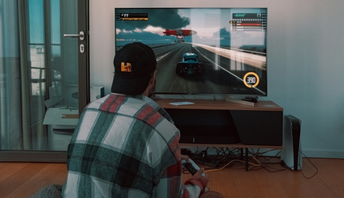 A person playing a racing game on a home console
