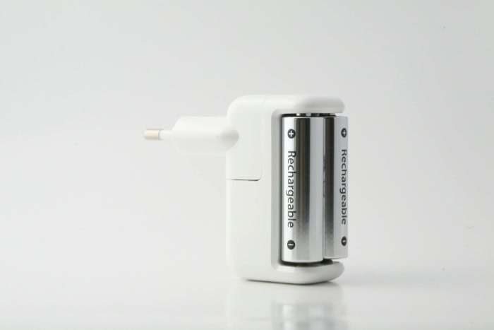 A plug in rechargeable battery charger with inserted AA batteries