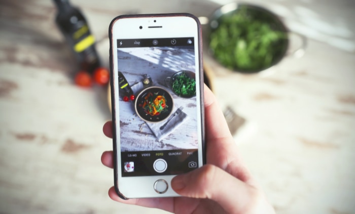 A smartphone capturing a photo of a meal