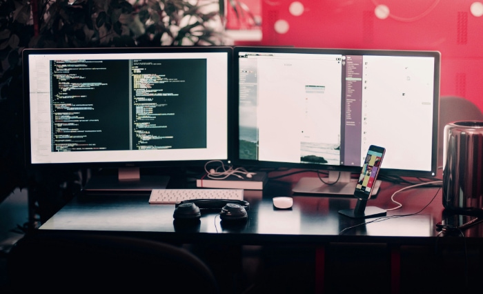 A well organized workspace with dual monitors displaying code