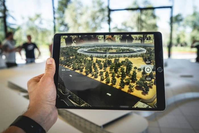 AR tablet showing virtual model of a building