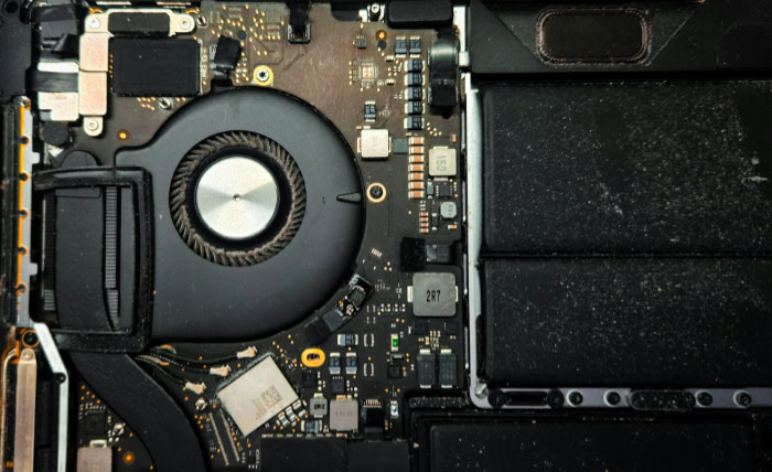 Accumulated dust on internal laptop cooling fan