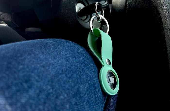 AirTag attached to a keyring in a car ignition