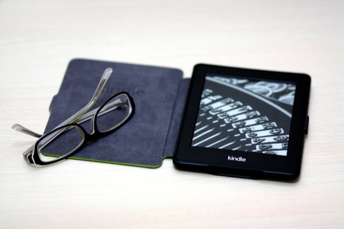 Amazon Kindle e reader with glasses on a case