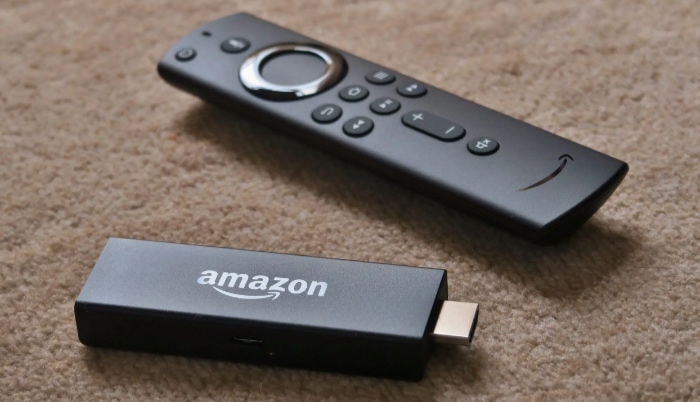 Amazon firestick with remote on carpet