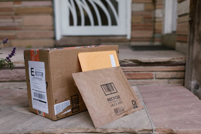 Amazon packages and mailers delivered on a doorstep resized