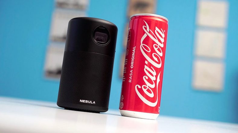 Black Anker Nebula Capsule beside coca cola can