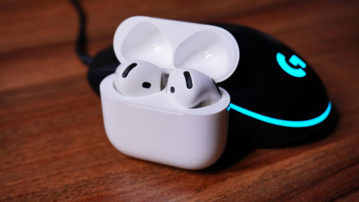Apple AirPods 4 case beside Logitech gaming mouse