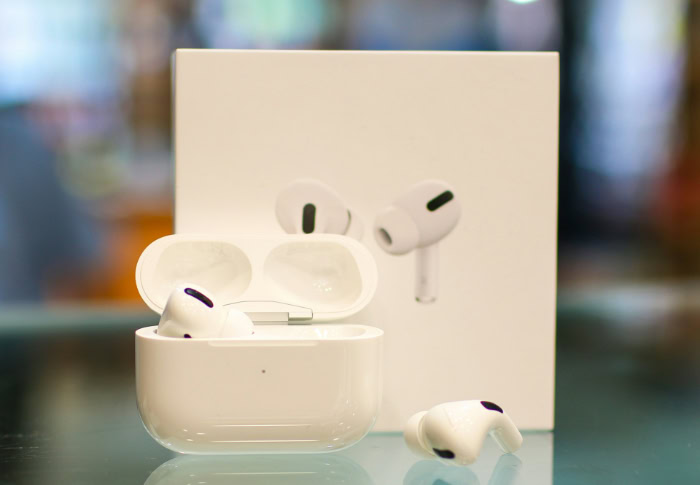 Apple AirPods Pro 2 on reflective surface with