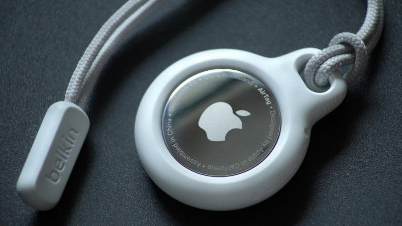 Apple AirTag in a white Belkin strap holder