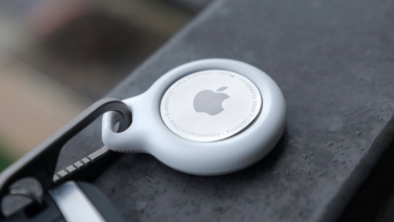 Apple AirTag in white protective case on keychain