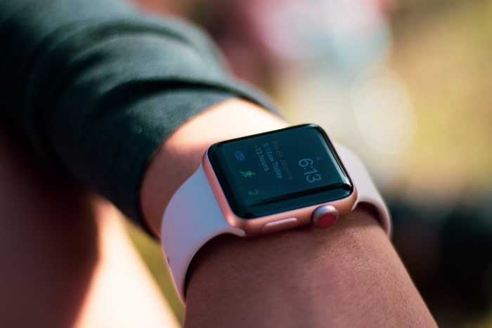 Apple Watch on wrist showing time and fitness data