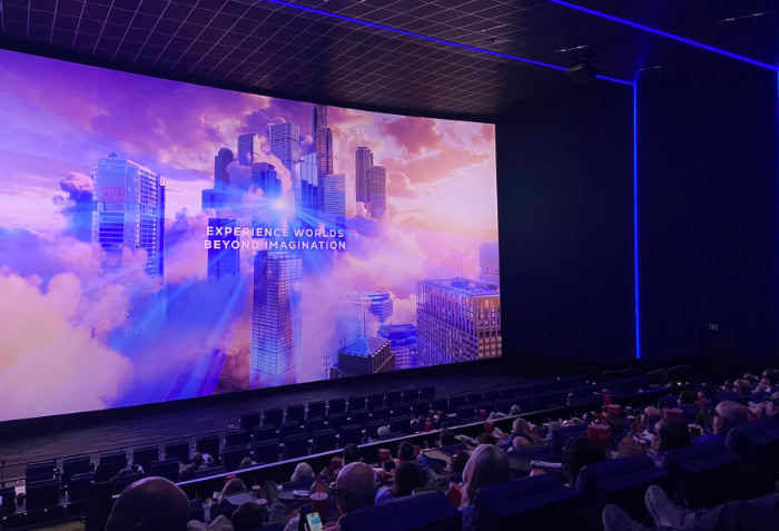Audience watching colorful movie on giant IMAX screen
