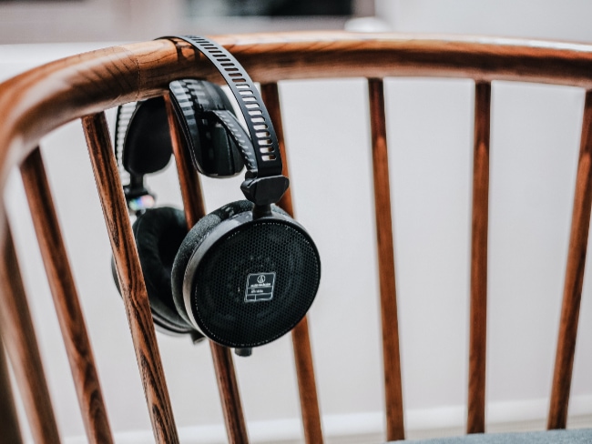 Black Audio Technica headphone on wooden chair