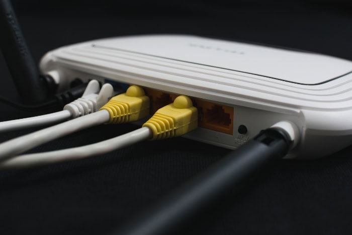 Back view of a Wi Fi router with cables