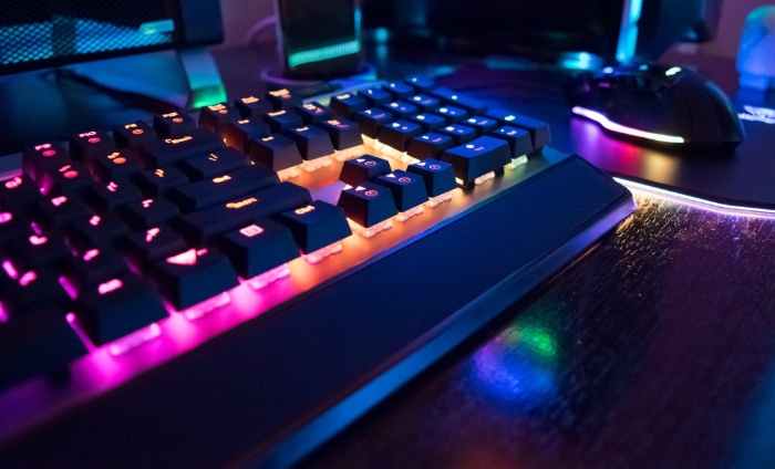 Backlit mechanical keyboard with vibrant RGB lighting alongside a gaming mouse