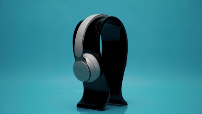 Gray Beats Solo Pro on black headphone stand