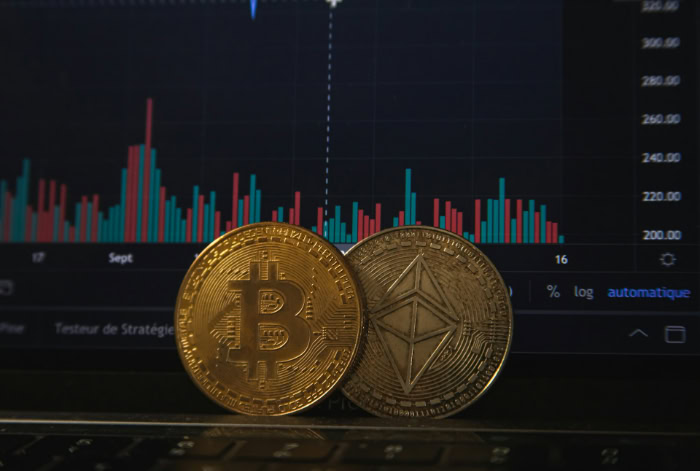 Bitcoin and Ethereum coins in front of a financial chart