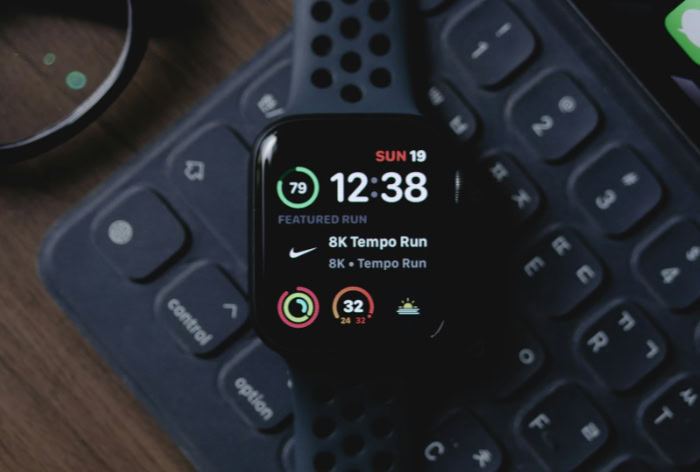 Black Apple Watch displaying Nike Run Club fitness tracking