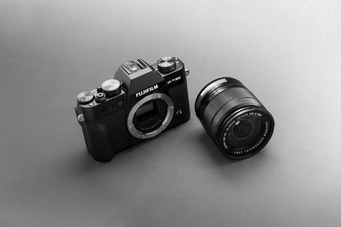 Black Fujifilm camera body with detached camera lens