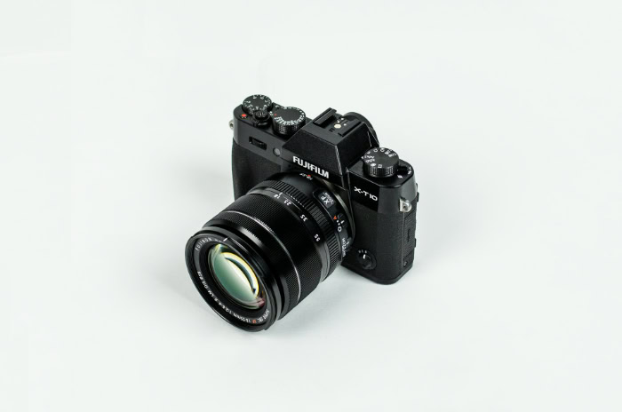 Black Fujifilm mirrorless camera with lens attached