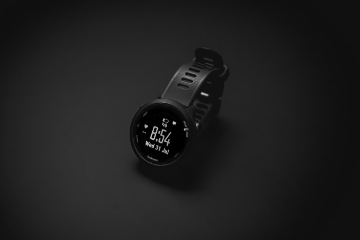 Black Garmin smartwatch displaying time on dark background