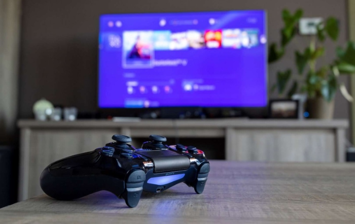 Black PS4 controller on table