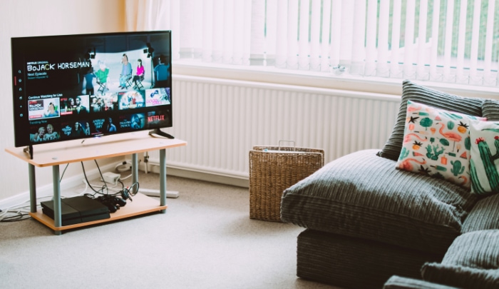 Black TV on wooden desk 1