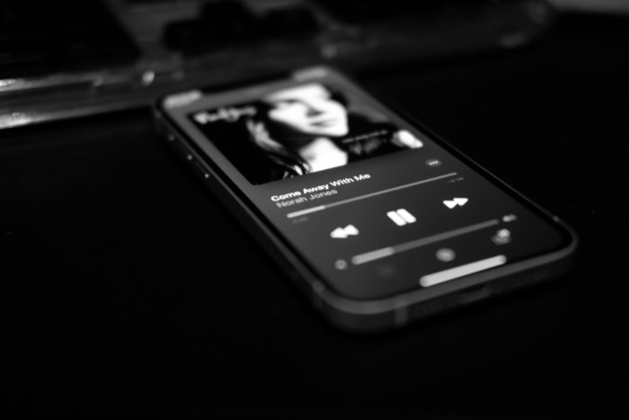 Black and white iPhone playing Norah Jones song