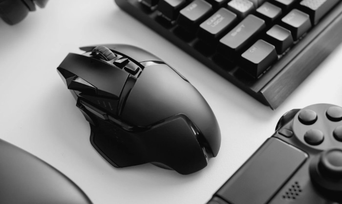 Black and white photo of a gaming mouse keyboard and controller
