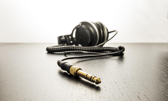 Black headphone with jack on wooden floor