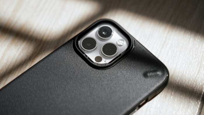 Black iPhone with triple lens camera in dark protective case