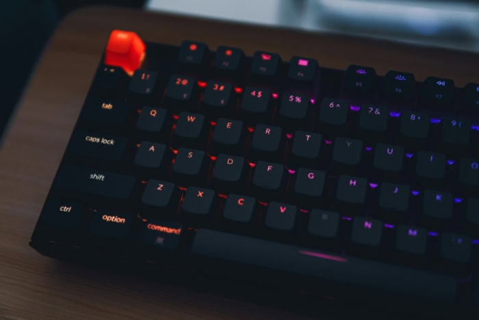 Black mechanical keyboard with RGB lighting in a dark setting