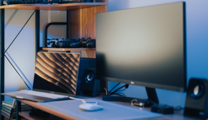 Black monitor on wooden desk