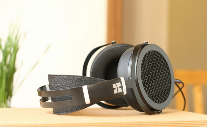 Black over ear headphones with leather band on wood