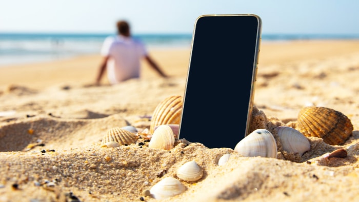 Black smartphone on the beach