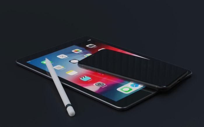 Black smartphone on top of a tablet with a stylus