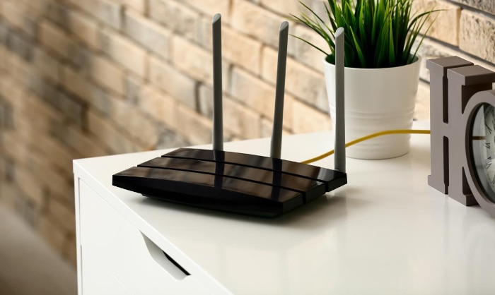 Black wifi router near plant