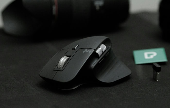 Black wireless computer mouse on dark surface