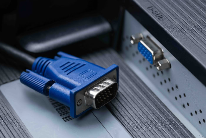 Blue VGA connector cable next to monitor port