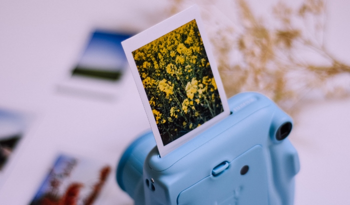 Blue instant camera with a photo film