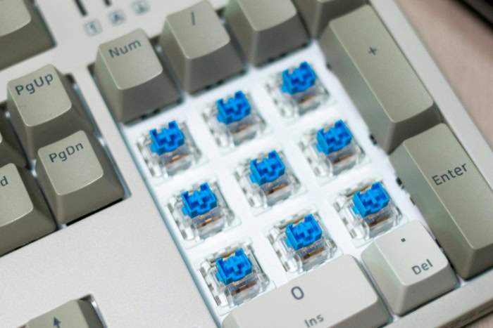 Blue mechanical switches exposed on keyboard numpad