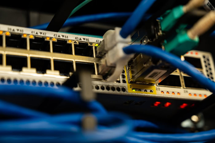 Blue network cables plugged into Ethernet switch
