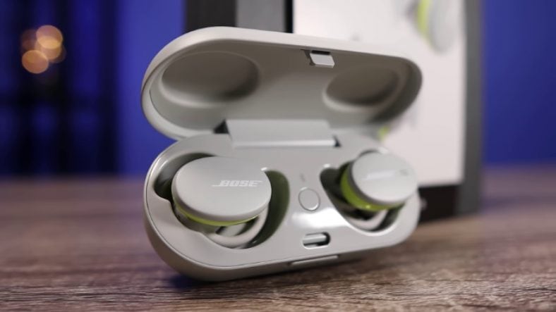 White Bose Sport Earbuds inside open case on table